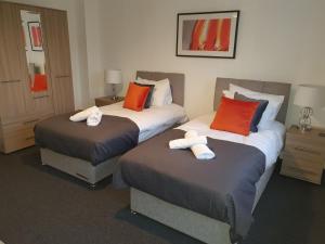 a hotel room with two beds with towels on them at Comfortable and Welcoming Beatrix House by Cliftonvalley Apartments in Bristol