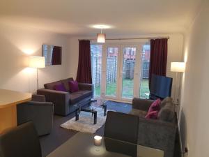 a living room with two couches and a television at Comfortable and Welcoming Beatrix House by Cliftonvalley Apartments in Bristol