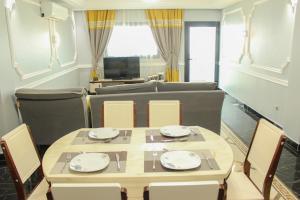a dining room with a table and chairs at IMD Residence in Douala