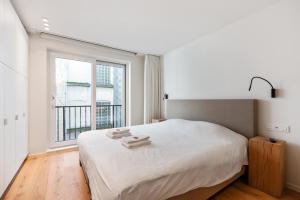 Llit o llits en una habitació de Hyper-Luxeappartement, zeezicht, centrum, airco, optie hotelservices