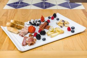 a plate filled with different types of food on a table at Hotel Milagro, Puebla Centro in Puebla