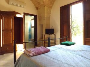 A bed or beds in a room at Masseria Cricelli