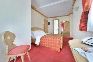 Postel nebo postele na pokoji v ubytování Hotel Cristallo