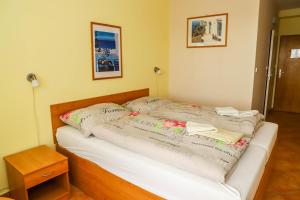Postel nebo postele na pokoji v ubytování Hotel Zátoka