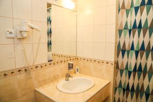 a bathroom with a sink and a mirror at Hotel Zátoka in Senec