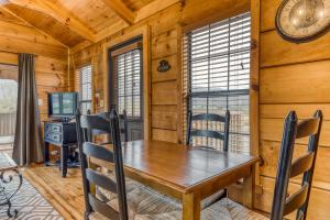 a dining room with a table and a desk at Calvery Cabin in Sevierville