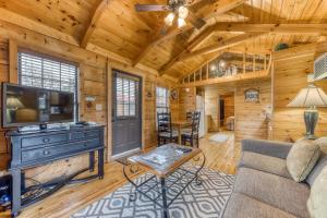 a living room with a tv and a couch at Calvery Cabin in Sevierville