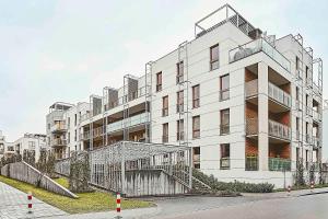 a large white building with a staircase in front of it at IRS ROYAL APARTMENTS Apartamenty IRS Nadmorski Dwór in Gdańsk