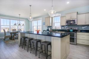 a kitchen with a large island with bar stools at Blue Haven in South Haven