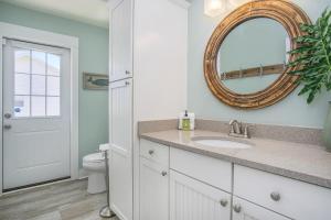 a bathroom with a sink and a mirror and a toilet at Blue Haven in South Haven +26 photos