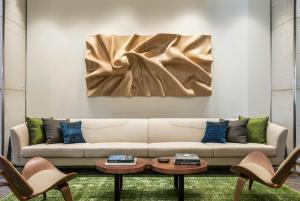 a living room with a couch and a painting on the wall at Kimpton Aertson Hotel by IHG in Nashville