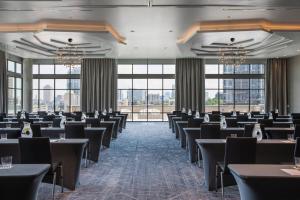 a conference room with tables and chairs and windows at Kimpton Aertson Hotel by IHG in Nashville +116 photos