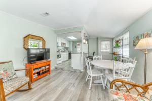a kitchen and living room with a table and a tv at Beach Cottage on Jones in Tybee Island