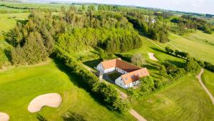 an aerial view of a house on a golf course at Hjarbæk Fjord Golfcenter in Skals