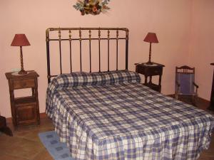 a bedroom with a bed with a checkered blanket at Casa El Menúo in Parauta