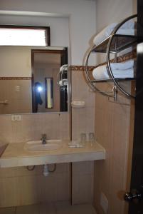 a bathroom with a sink and a mirror at Colonial Plaza Hotel in Puno +74 photos