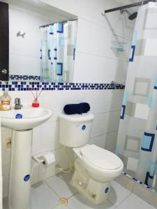 a bathroom with a toilet and a sink at Apartamento Marbella #2-14 in Cartagena de Indias