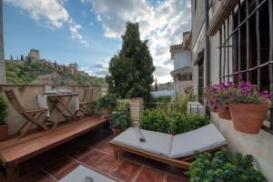 a balcony with a bench and a table at The Lovers Boutique in Granada