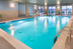 a large swimming pool with blue water at Holiday Inn Express & Suites - Romeoville - Joliet North, an IHG Hotel in Romeoville