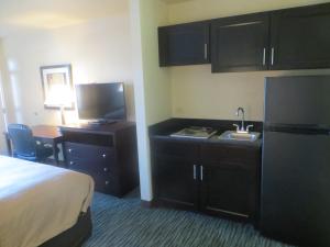 A kitchen or kitchenette at Garden Inn and Suites