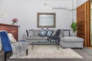 a living room with a couch and a table at Princes Wharf - Absolute Waterfront & Great Views in Auckland