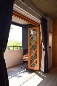 a door leading into a room with a window at Pannana Cha-am in Cha Am