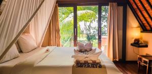 Postel nebo postele na pokoji v ubytování Kaluku Gili Resort + 37 fotografií