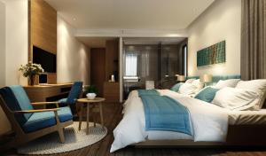 a bedroom with a bed and a desk and a chair at Trang Ngan Hotel by THG in Danang