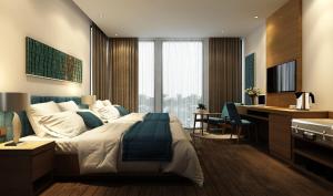 a hotel room with a large bed and a desk at Trang Ngan Hotel by THG in Danang