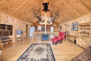 a large living room with wooden walls and a ceiling with deer heads at Family-Friendly Troy Getaway with Furnished Deck! in Unity