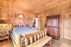 a bedroom with a bed and a wooden wall at Family-Friendly Troy Getaway with Furnished Deck! in Unity