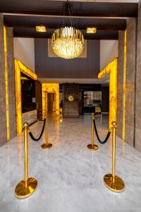 a lobby with a chandelier and rope barriers at SUITS HOTEl تشغيل مؤسسه سويت لتشغيل الفنادق in Jeddah