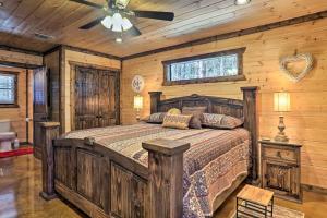 a bedroom with a bed and a ceiling fan at The Breeze Forested Oasis with Hot Tub and Deck! in Broken Bow