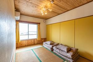 a living room with two couches and a window at 47HOSTEL in Wadomari