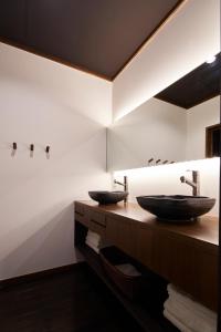 a bathroom with two sinks and a mirror at Wanoi Kakunodate in Senboku