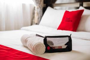 a hotel room with a towel and a bag on a bed at RedDoorz @ Poblacion Sur Sigma in Sigma