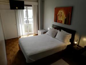 Postel nebo postele na pokoji v ubytování Hotel Dom Joao IV