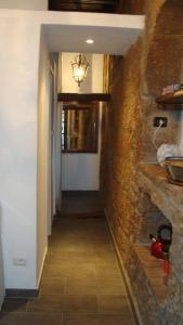 um corredor que leva a uma cozinha com uma parede de pedra em Casalio em Barbarano Romano