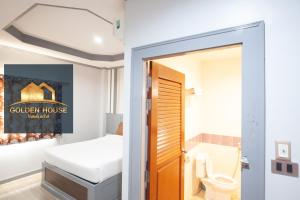a bathroom with a bed and a toilet in a room at Golden House Hotel Sakaeo in Sa Kaeo +103 photos
