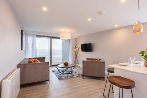 a living room with a couch and a table at Metro Hotel Dublin Airport in Santry