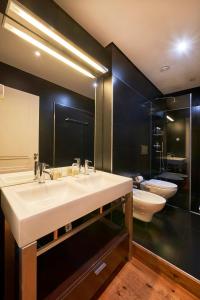 a bathroom with two sinks and a large mirror at Lisbon Five Stars Apartments São Paulo 55 in Lisbon