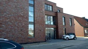 a white car parked in front of a brick building at Refugium am Wasserturm in Emsdetten