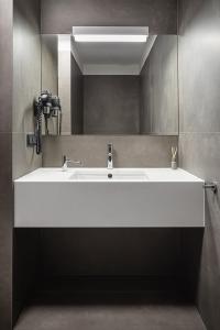 a bathroom with a white sink and a mirror at Home & Work in Pulheim