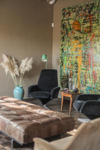 a living room with a couch and a painting on the wall at Podere San Pasquale in Castiglione dʼOrcia +43 photos