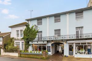 ein weißes Gebäude mit einem Balkon darauf in der Unterkunft Morleys Rooms - Located in the heart of Hurstpierpoint by Huluki Sussex Stays in Hurstpierpoint