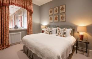 a bedroom with a bed and a window at The Maitland at Thirlestane Castle in Lauder