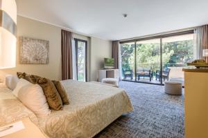 A bed or beds in a room at Lago Garden Apart-Suites & Spa Hotel