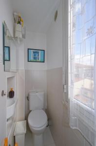 a bathroom with a toilet and a sink and a window at Piazzadarmi 26 in Ancona
