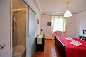 a bedroom with a red bed and a shower at Piazzadarmi 26 in Ancona