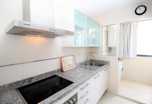a kitchen with a sink and a counter top at Apartamento Gema Gemelos 26 in Benidorm +13 photos